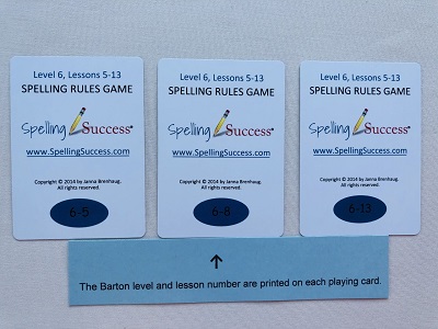 Level 6 Lessons 5-13 Spelling Rules Game with blue paper pointing to the Barton level and lesson of each card