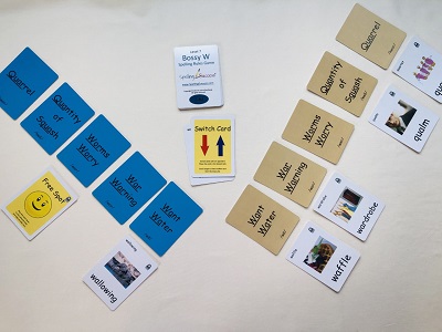 level 7 bossy W spelling rules game set up with blue cards and tan educational cards with discard pile in middle